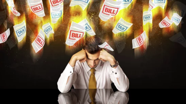 Business man worried and stressed by tax bills